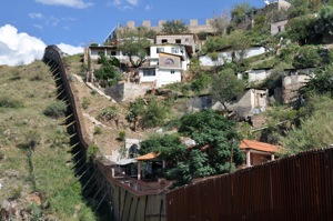 The wall in Nogales that divides the United States from Mexico. The city of Heroica Nogales (Sonora, Mexico) can be seen across the barrier.