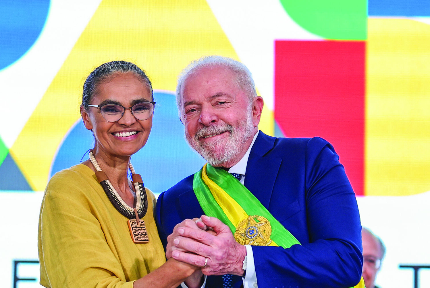 Environment and Climate Change Minister Marina Silva and President Luiz Inácio Lula Da Silva smiling and embracing.